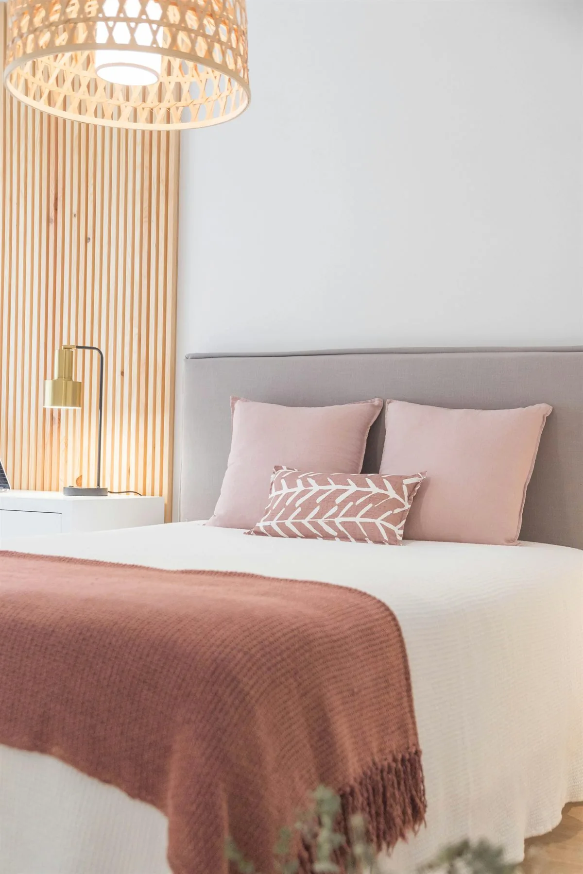 Muted earthy bedroom with layered linens and warm tones