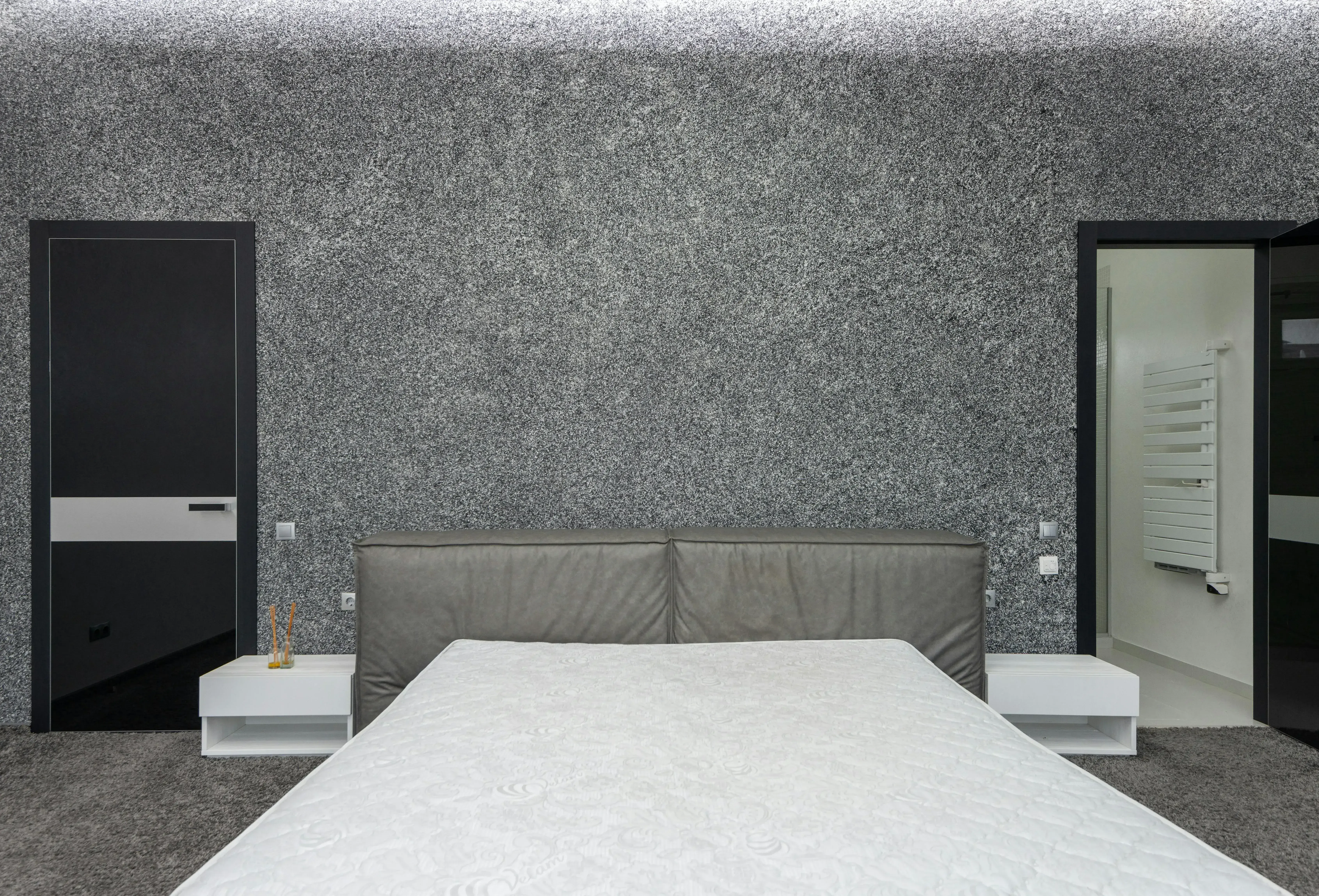 Bedroom with the bed positioned between two door openings, creating a more exposed and less protected layout