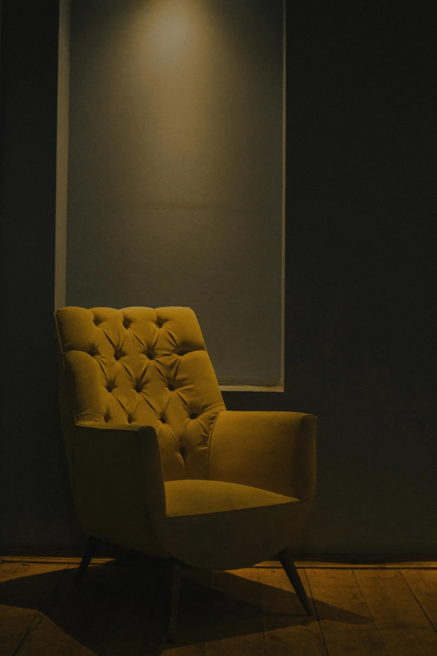 Amber accent chair against a darker wall showing a warm fire element color in a small dose