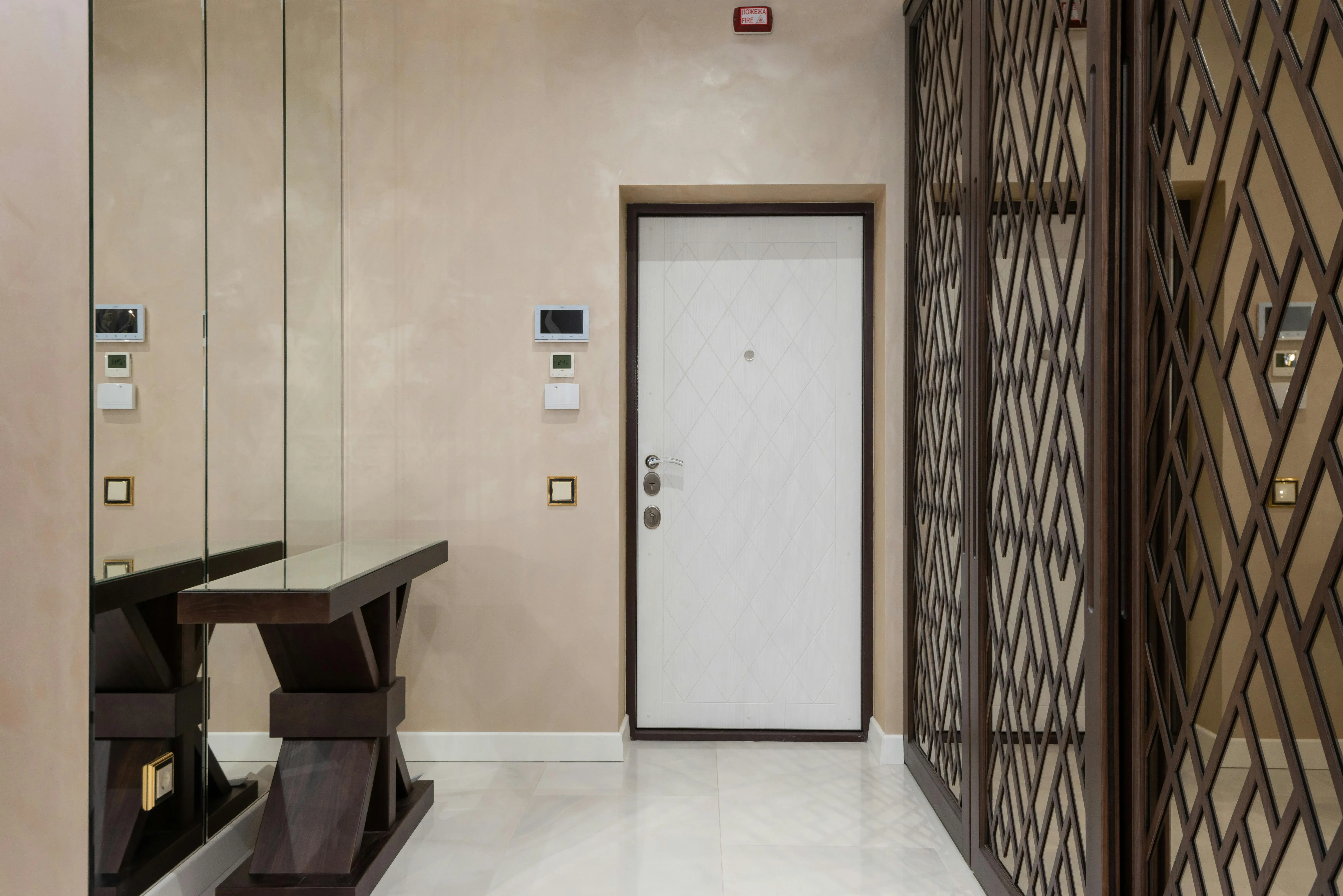 Minimal hallway entry with a clean console, clear wall space, and unobstructed front door