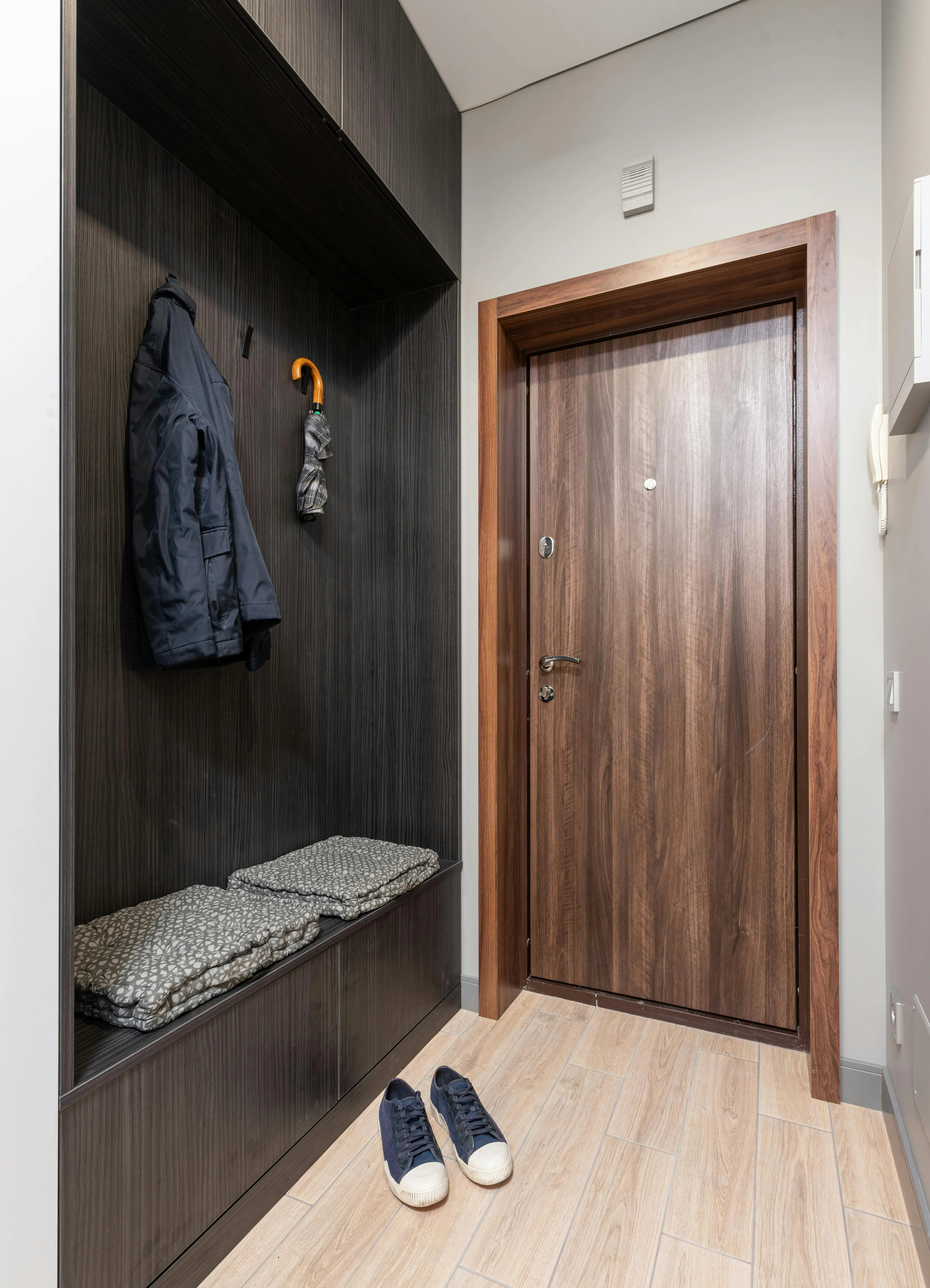 Organized entry with a bench, coat hooks, and a clear path to the front door