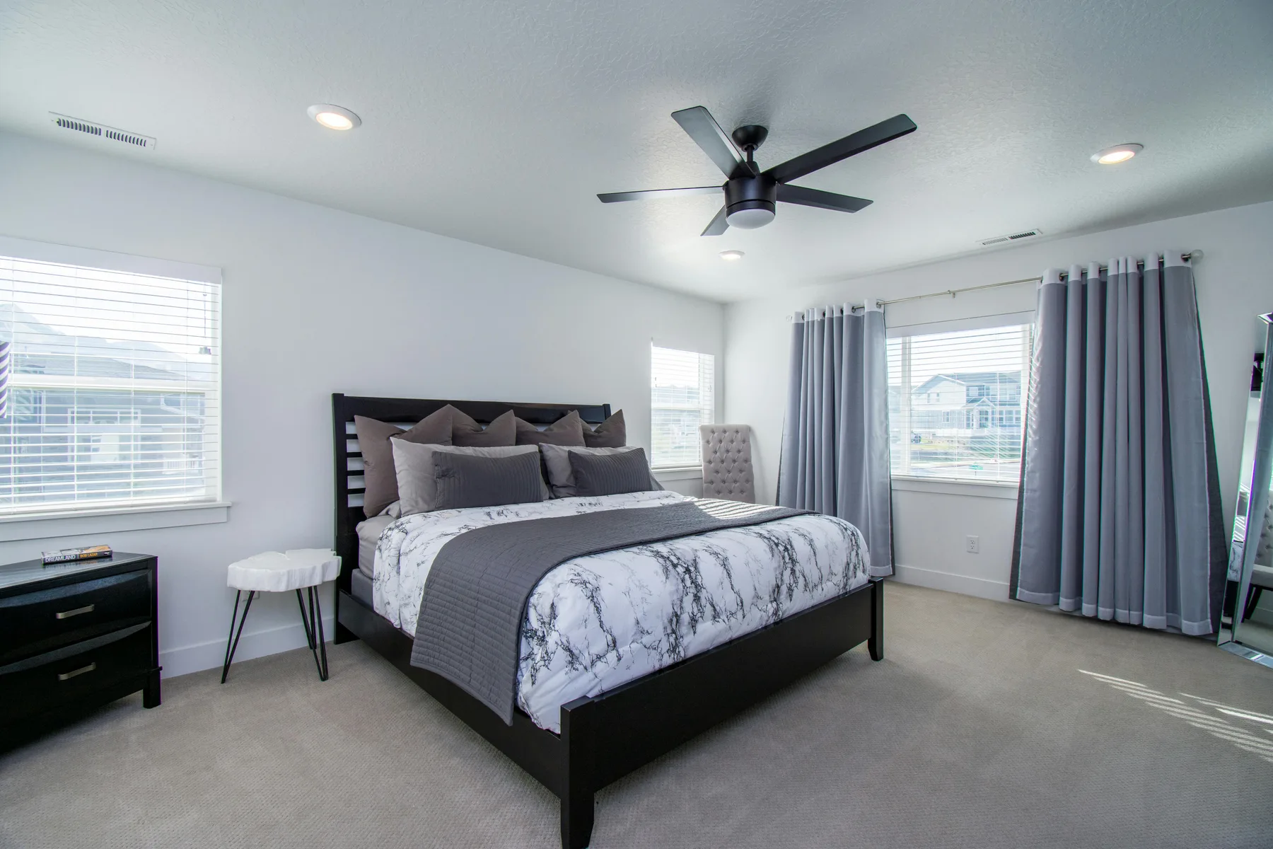 Tidy bedroom with calmer styling, cleaner surfaces, and less visual competition around the bed