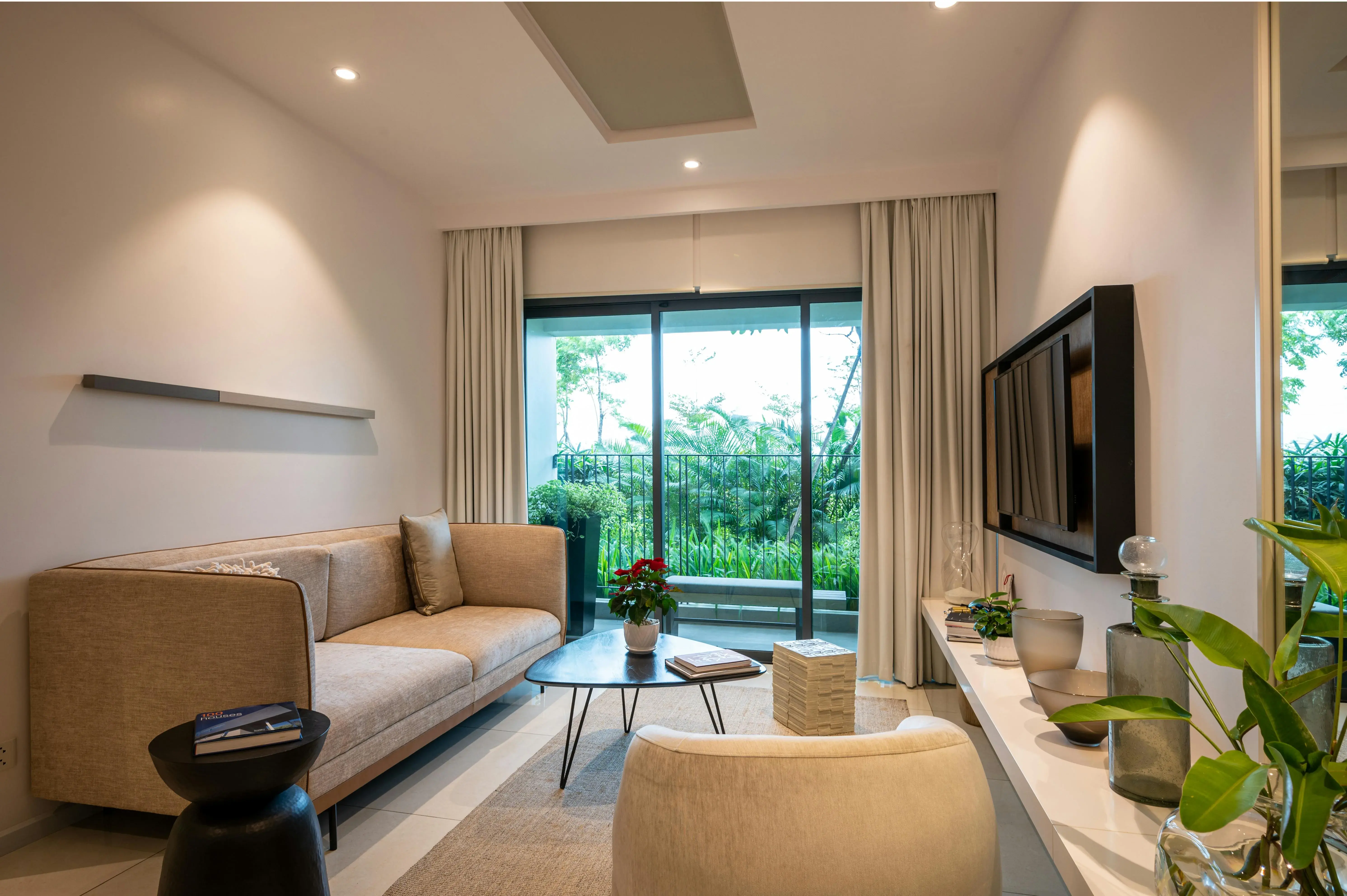 Living room with a television wall, seating group, and multiple visual anchors competing for attention