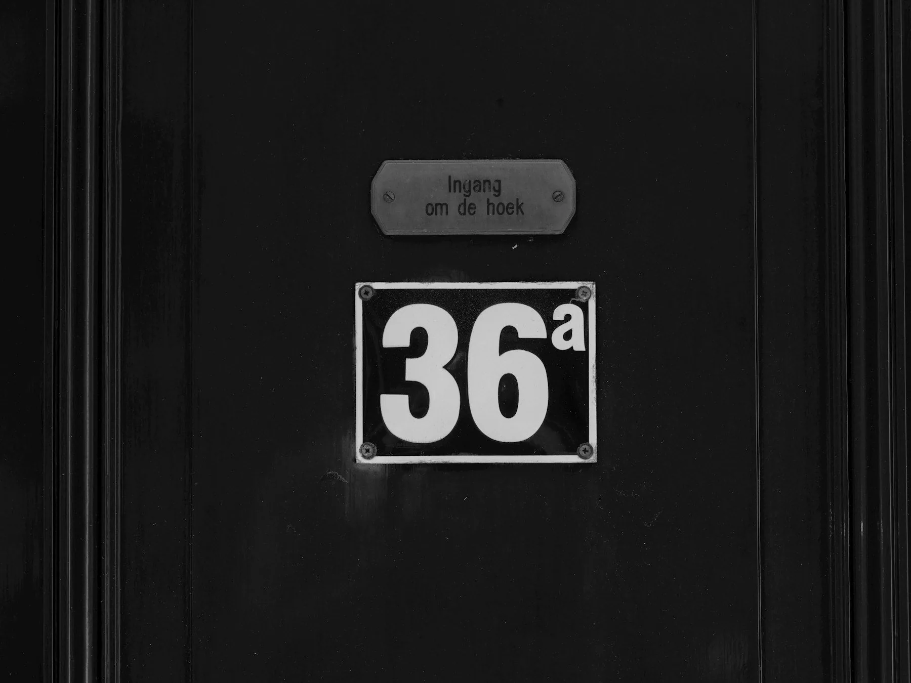 Front entry with a clearly visible house number sign beside the door
