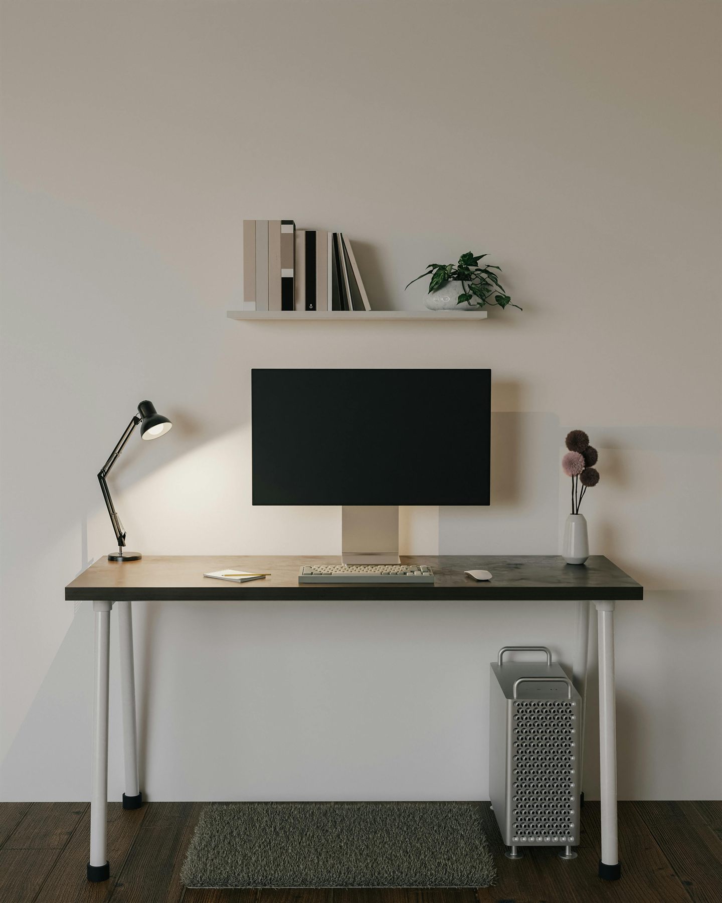 Desk with monitor, lamp, small shelf, and a warm neutral wall