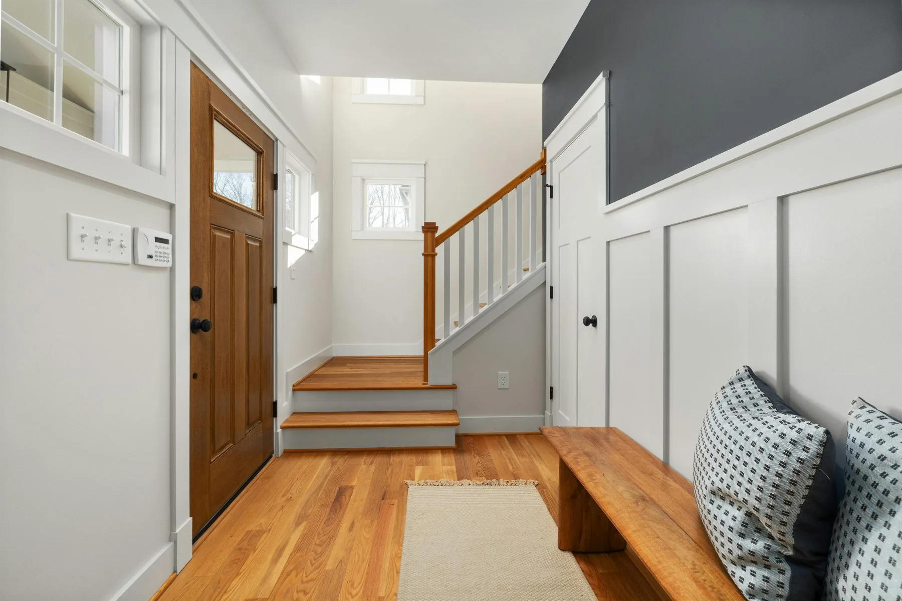 Clear warm entryway with a centered console, mirror, and easy open pathway