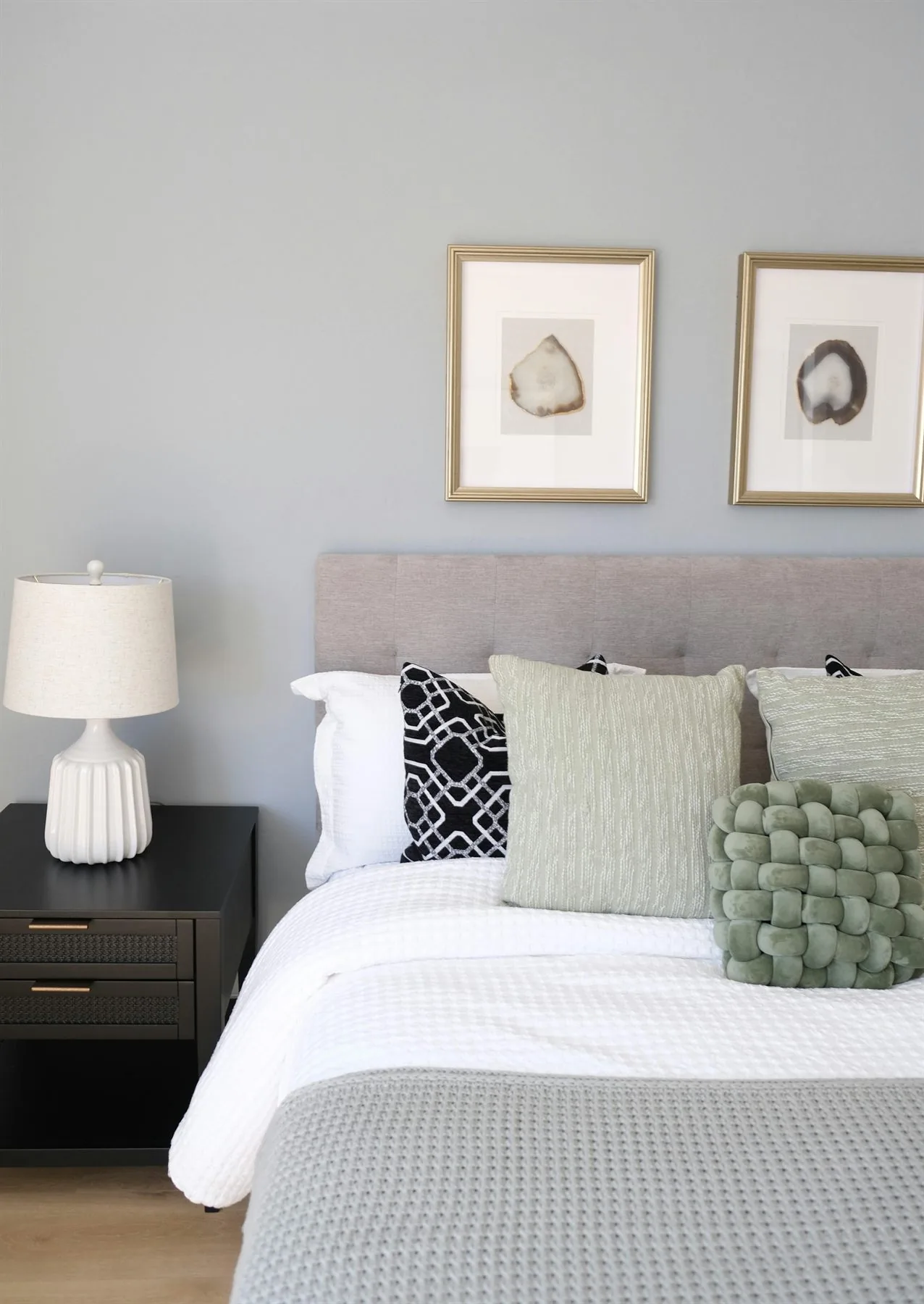 Calm bedroom with soft wall color, grounded bed, and a visually quiet layout