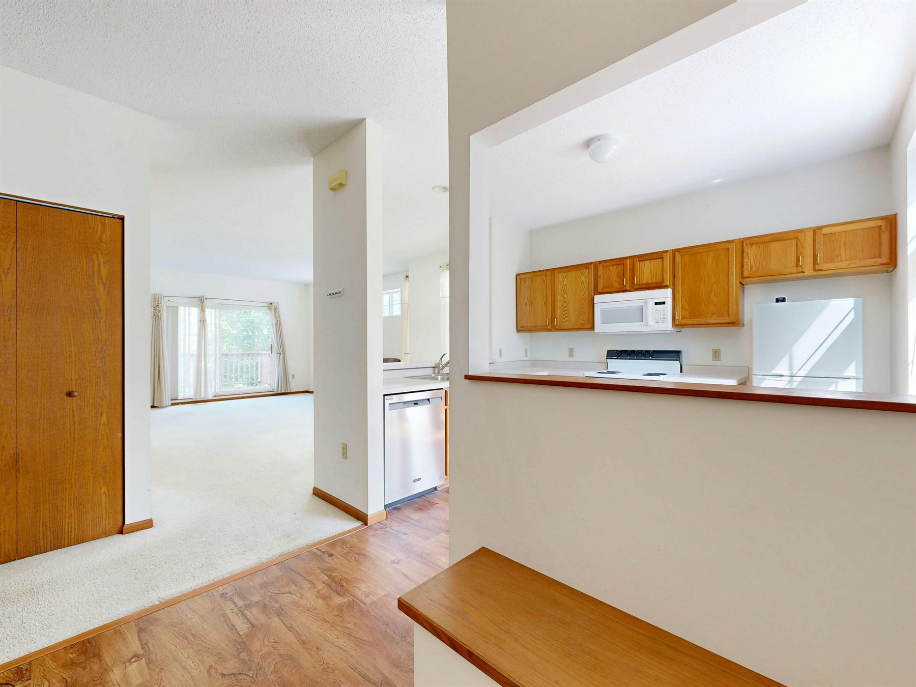 Open-plan room with warm light, readable zones, and easy circulation between living and dining areas
