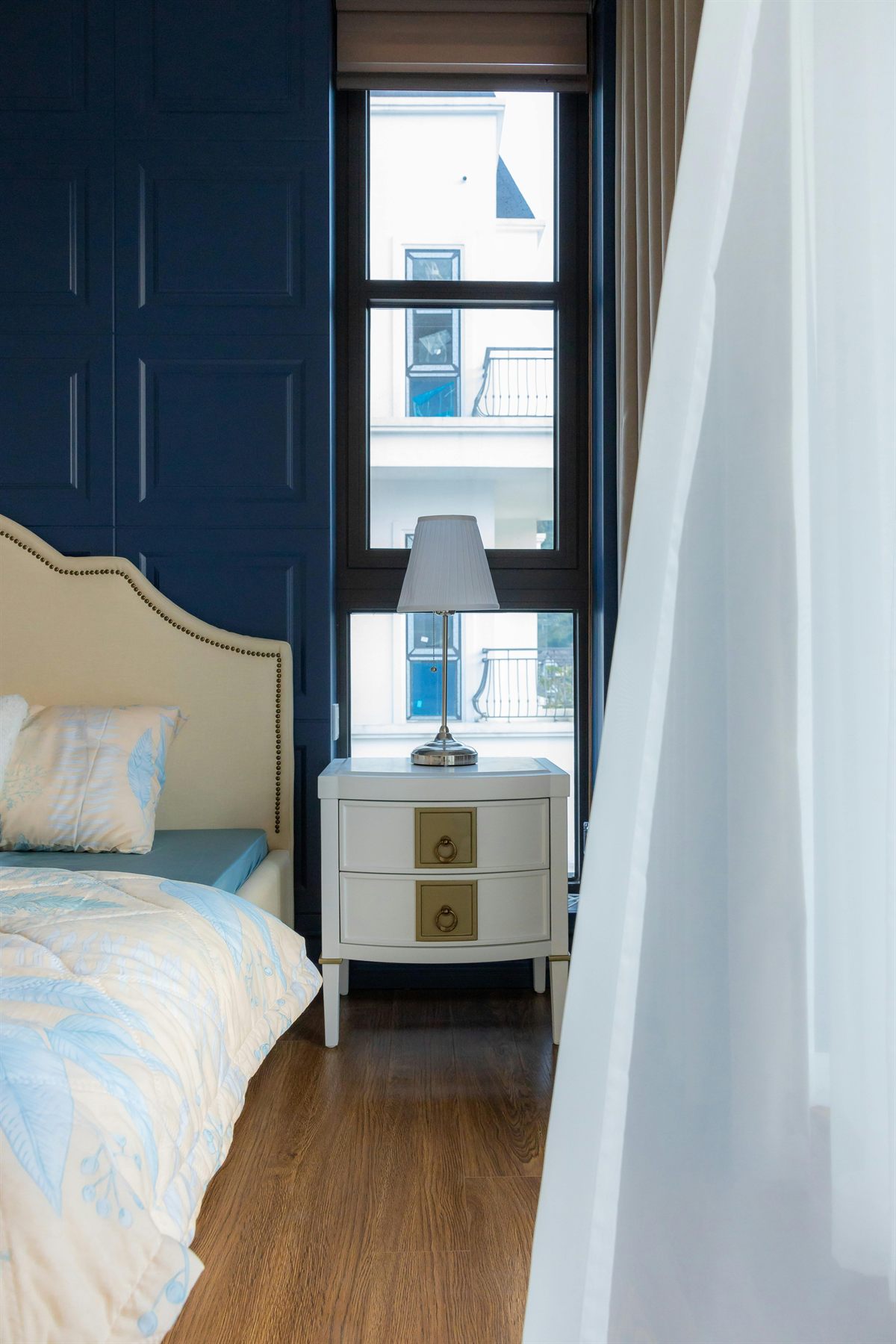 Blue bedroom with softer layered bedding and a calmer water element color direction