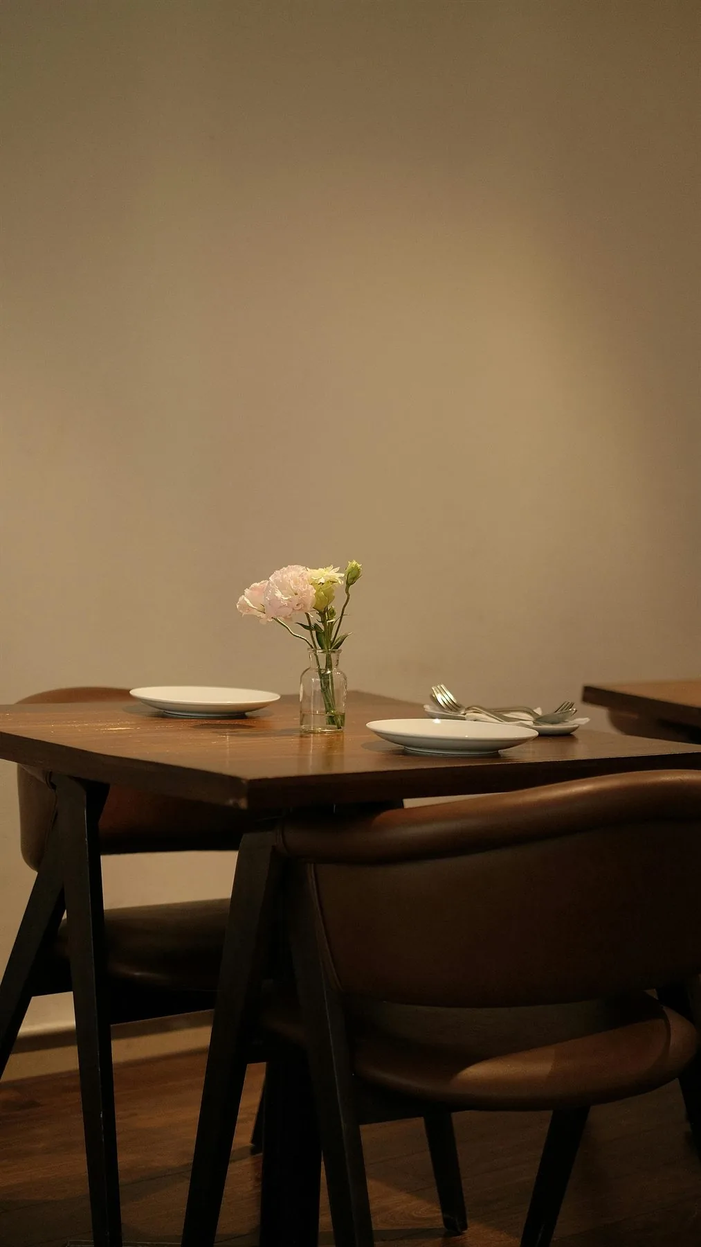 Sunlit dining table with flowers, warm wood, and a nourishing welcoming setup
