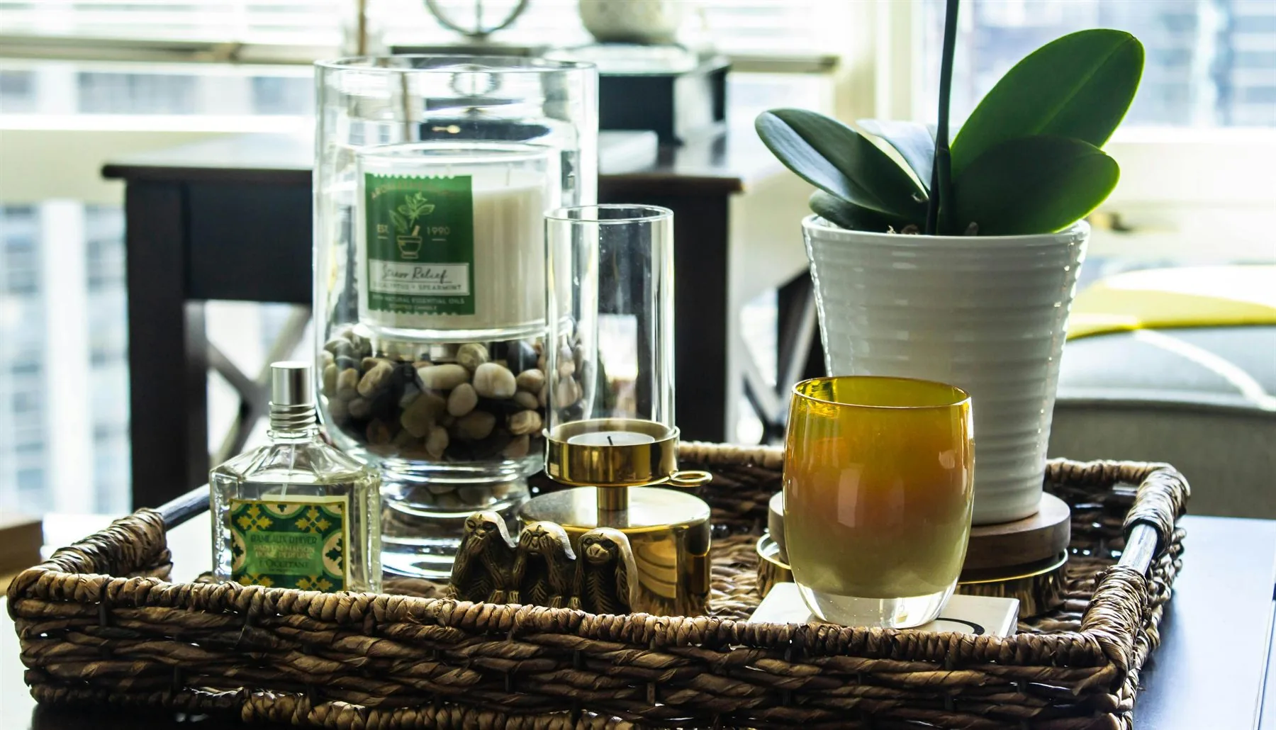 Woven tray with candle, plant, and a few edited decor items